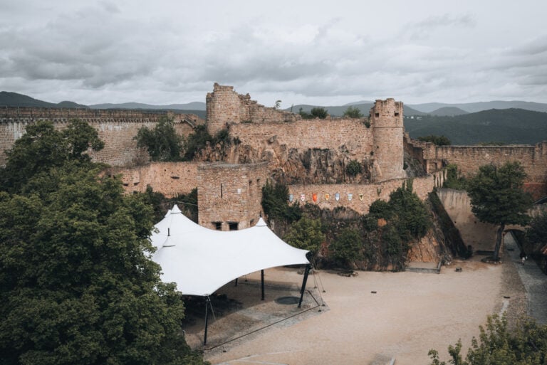 14th Century cistern and watch towers of the Château du Hohlandsbourg overlooking the Alsace Plain and the Vosges Mountains on a clear day. The historic fortress introduces what to expect when visiting the Château du Hohlandsbourg.