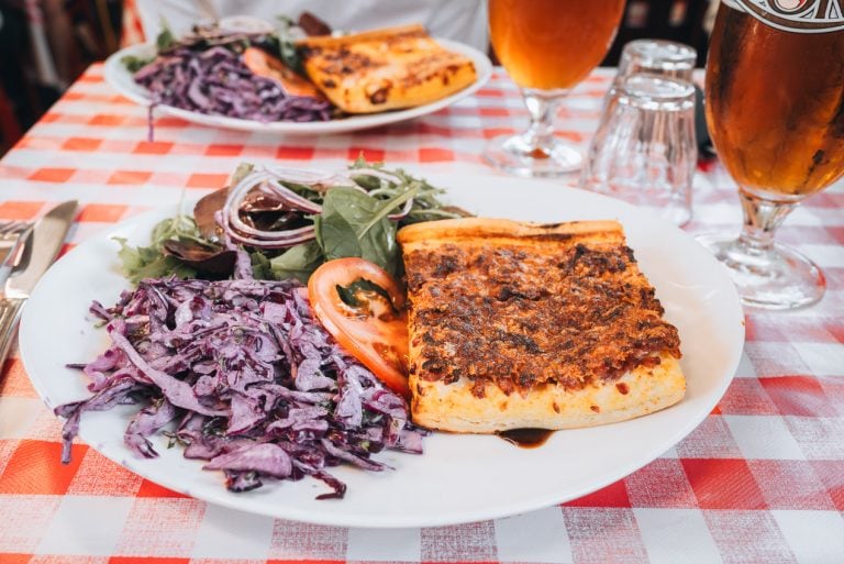 This is a Quiche Lorraine at Chez Mauricette in Metz. It's on a dish with a large salad.