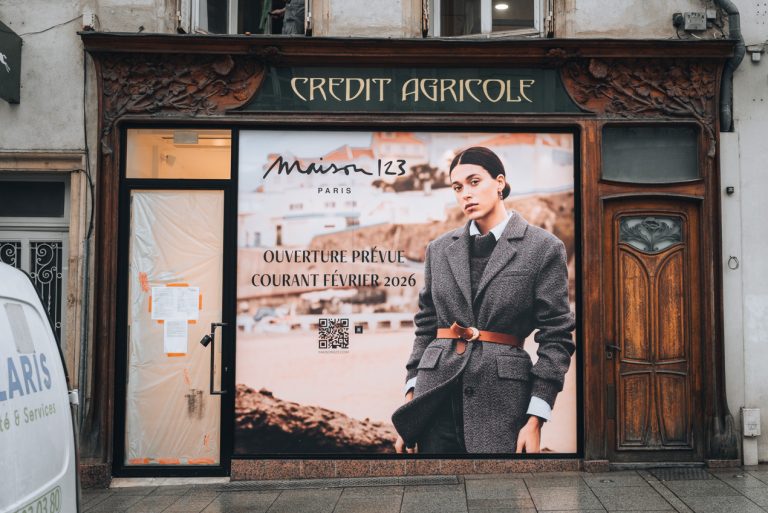 This is the Ancien Magasin Goudchaux in Nancy. The frame of the store and the door on the right are made of wood and decorated with flowery designs.