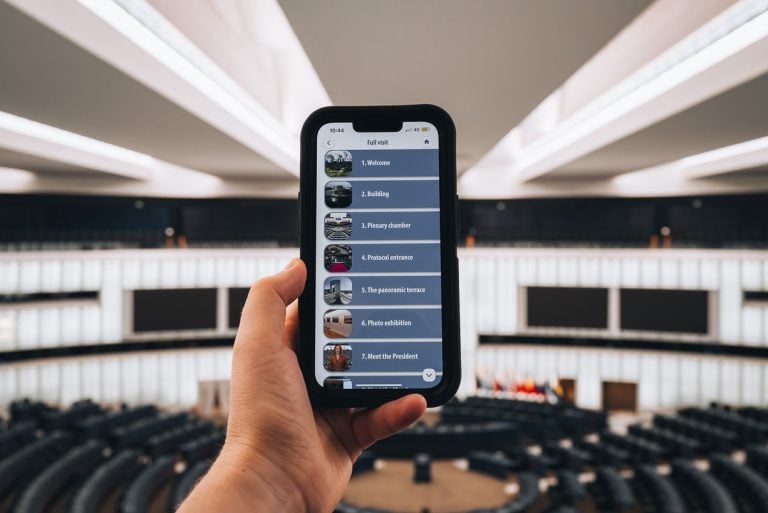 This is the audio guided tour on my cellphone at the European Parliament. I'm holding my cellphone in the plenary session room and it shows the different steps of the tour. 