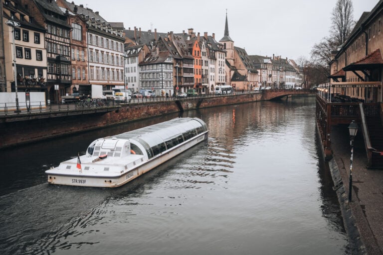 Batorama sightseeing boat cruising through Strasbourg's canals on a winter day with historic buildings lining the waterfront. A boat tour offers a different perspective on the city and is one of the most memorable experiences.