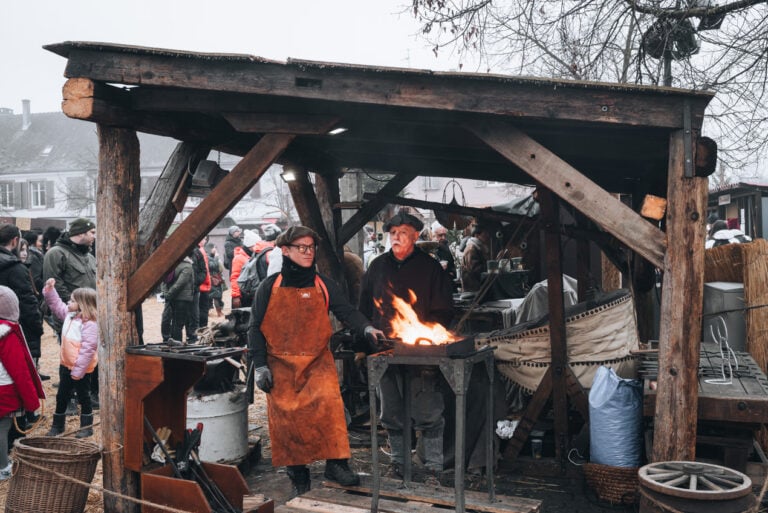 Blacksmith heating their iron rods in a fire. This is one of the trades that is on display at Christmas time in Neuf-Brisach.