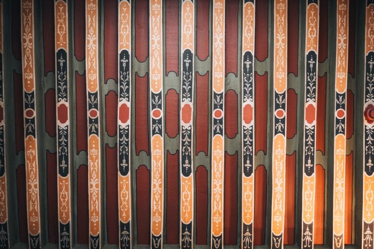 This is the ceiling inside the Hotel de Vogue in Dijon. It's has alternating wooden panels and each one is painted with various designs and colors.