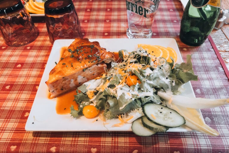 Golden baked chicken torte served on a plate at Le Fer Rouge in Colmar with flaky pastry crust and savory filling. The dish represents traditional Alsatian cuisine.