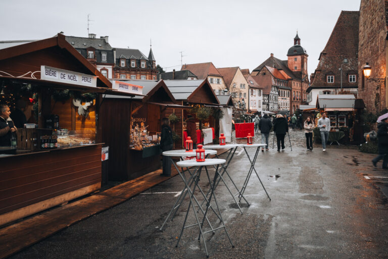 Wooden chalets along a paved road next to the Saint Peter and Paul church in Wissembourg.