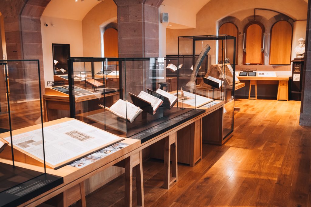 This is a collection of works at the Humanist Library in Selestat. They are all lined in a row and protected in a glass case.