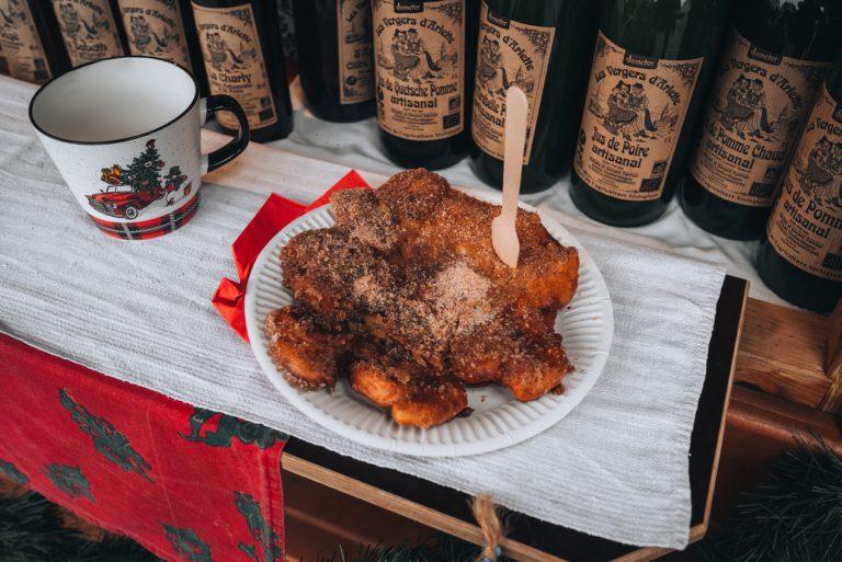 This is my crepe from Les Vergers d'Arlette at the Wissembourg Christmas market. It's on a paper plate with a wooden fork and next to it is my mug with apple cider.
