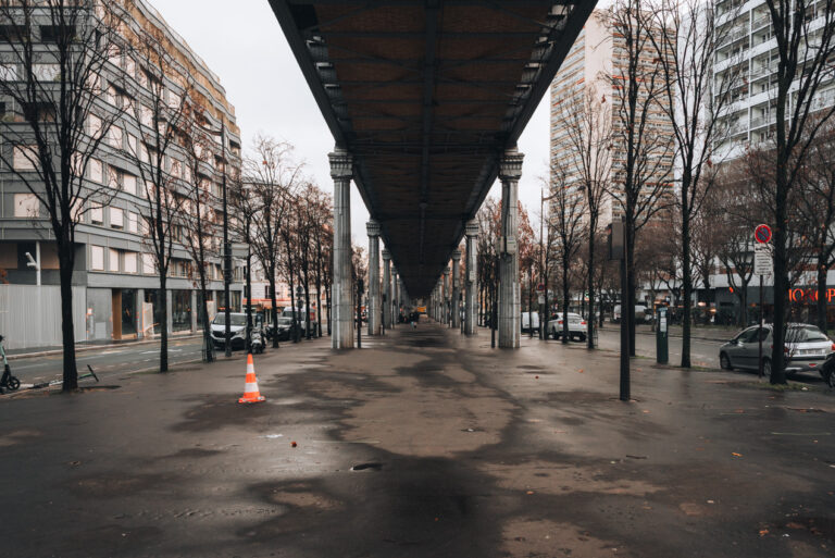 Street under Metro Line 6 in Paris. It's dirty with trash and leaves everywhere. It's one of the reasons Paris can be disappointing for some.