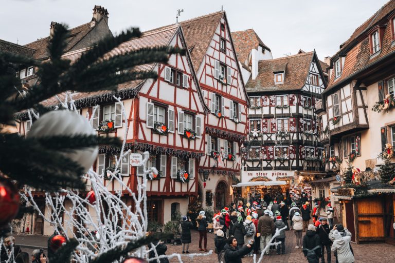 This is Grand Rue in Colmar before the opening of its Christmas market. There is a crowd of people trying to take photos.