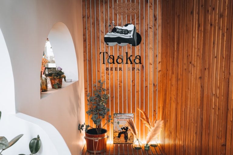 This is the entrance to Taaka Beer Spa. There is a sign with the name of the spa and some plants.