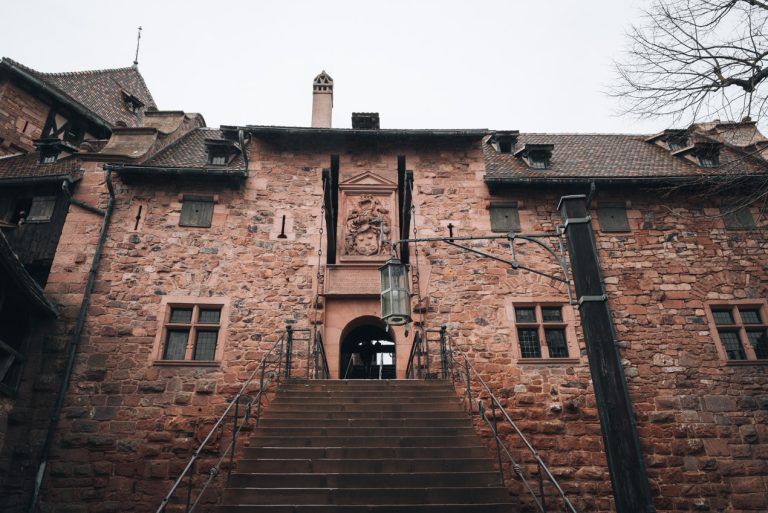 Stairs leading to the upper terraces at the Haut Koenigsbourg Castle. They are stone stairs and there is a small entrance at the top.