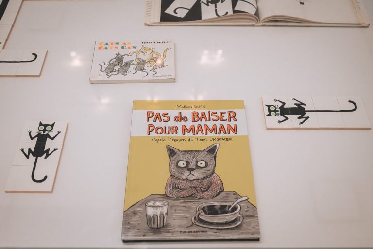 This is an exhibit at the Tomi Ungerer Museum. It shows a book and drawings of cats.