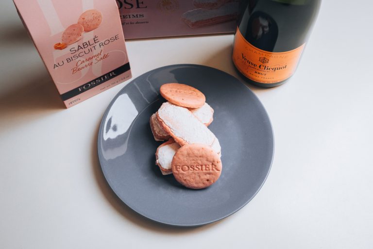 There is a plate of Fossier Biscuits from the shop in Reims. They are stacked on top of each other and have the word Fossier written on them.