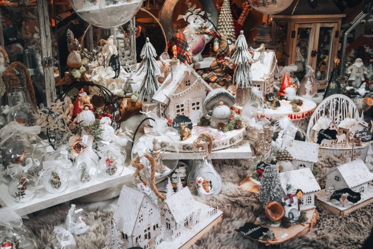 This is a selection of handmade Christmas ornaments in Eguisheim. There are elves, snow globes, and little houses.