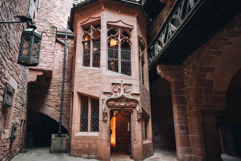 This is the inner courtyard of the Haut Koenigsbourg Castle. There is a small tower with an entrance. It leads to the upper levels of the castle.