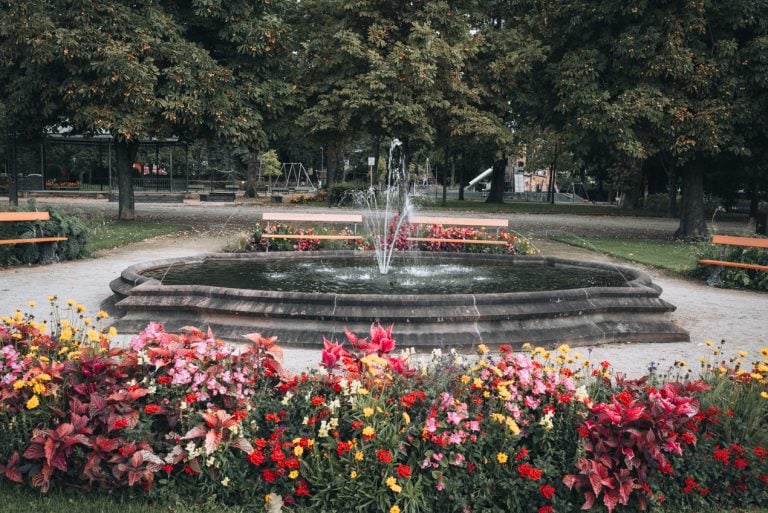 This is Jardin de Ville in Ribeauvillé. It's a small park with gardens, a fountain, walking paths, and benches. 