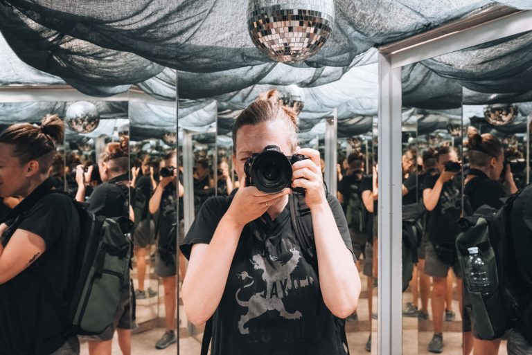 This is me, Jen Ciesielski, at the Maison d'Illusion EURL in Wissembourg. I'm taking a photo of myself in the room of mirrors so you see me several times. I'm wearing a t-shirt and hold my Nikon camera.