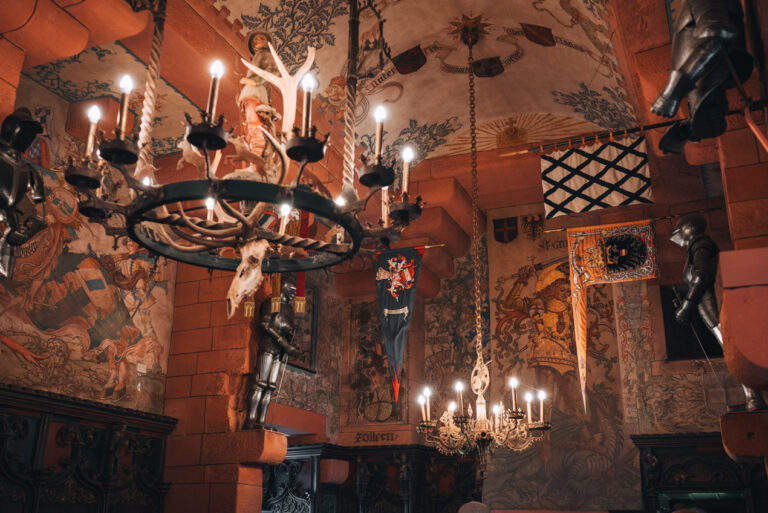 The Kaiser Hall at the Château du Haut-Koenigsbourg. It's decorated with hanging lights and tapestries. This is one of the coolest places to visit in winter.
