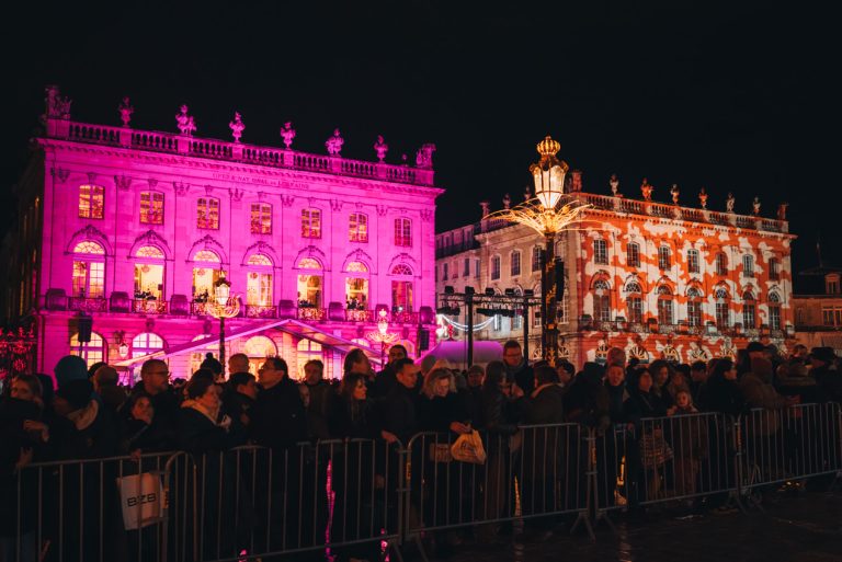 This is the light show in Place Stanislas in Nancy during the Christmas market. There are two buildings and each one has lights projected on to it.