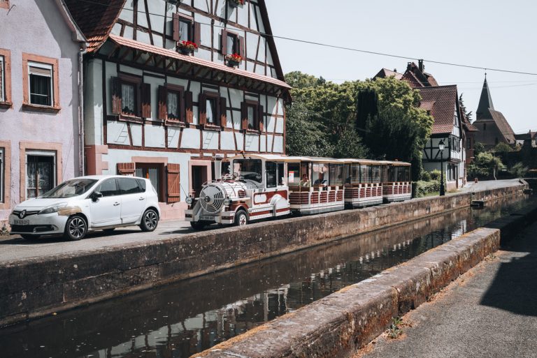This is a photo of the front of the Little Tourist Train in Wissembourg. It's a small white and brown train with glass windows.