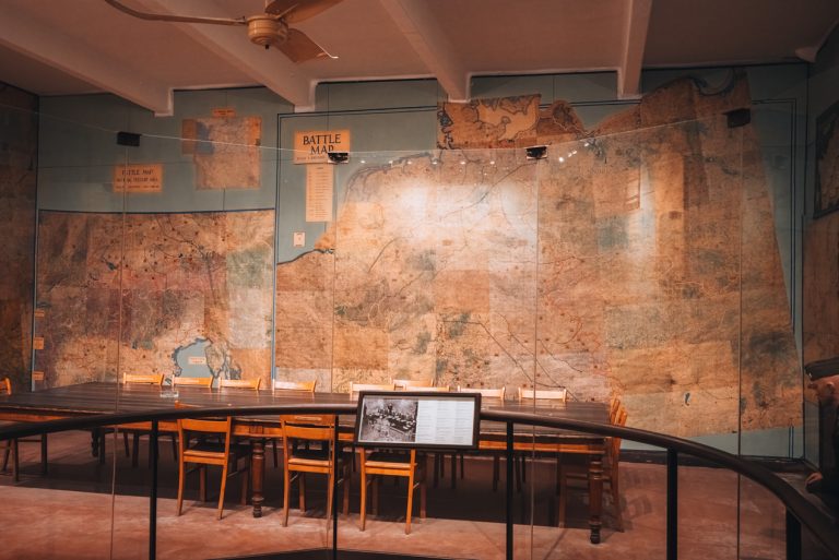 This is the Map room at the Musée de la Reddition in Reims. It shows the maps and the legends as well as an information board describing the scene. Everything is written in French and English.