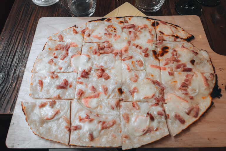 A thin tarte flambee from La Soi in Colmar topped with cheese, onions, and lardons.