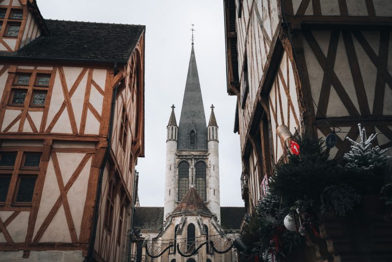 This is one view of the Notre Dame Cathedral in Dijon. This is the backside of the cathedral and here two half-timbered buildings frame the steeple. 