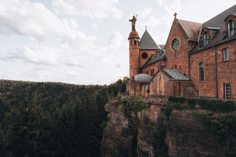 Panorama of the Mont Saint Odile monastery on a rocky outlook surrounded by the Vosges mountains.
