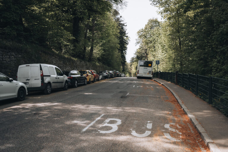 Road next to the Haut-Koenigsbourg Castle with cars parked along the side. This is the only parking at the castle.