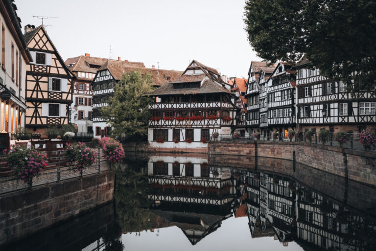White half-timbered houses line the canal in Place Benjamin Zix in the La Petite France neighborhood of Strasbourg. It's area that has architecture typical of Germany in Strasbourg.
