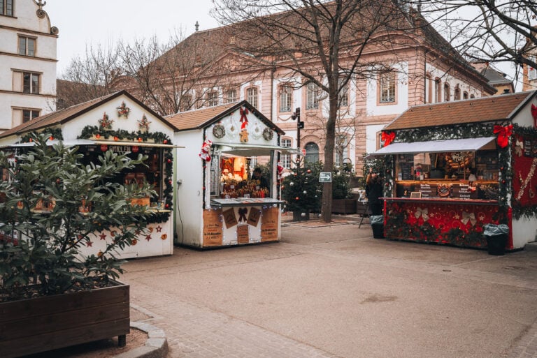 This is Place du Marché aux Fruits at Christmas in Colmar. It's a small square with three stalls selling food and handmade crafts.