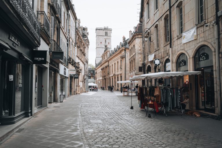 This is Rue des Forges in summer in Dijon. There is nobody in the street and the shops are open.