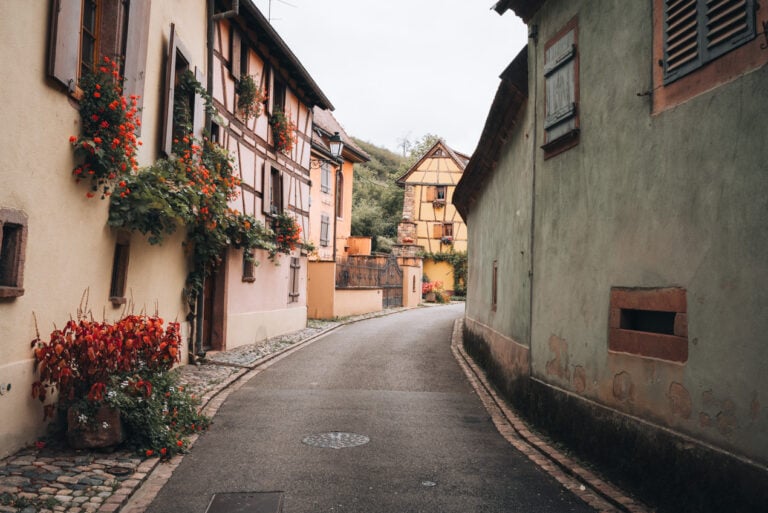 Rue des Vignerons lined with colorful timber framed buildings. This is one of the streets along the historical circuit in Turckheim.