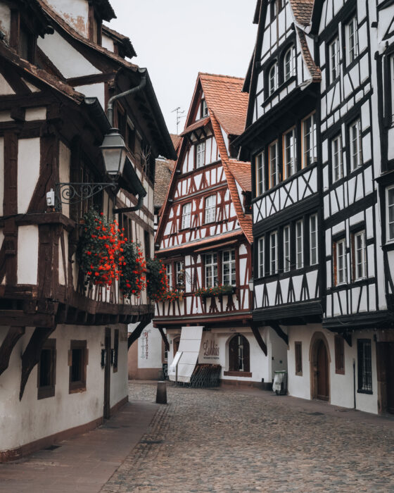 Strasbourg's Rue du Bain-aux-Plantes is a cobblestone street lined with white half-timbered houses. It’s a calm, quiet morning with nobody around.