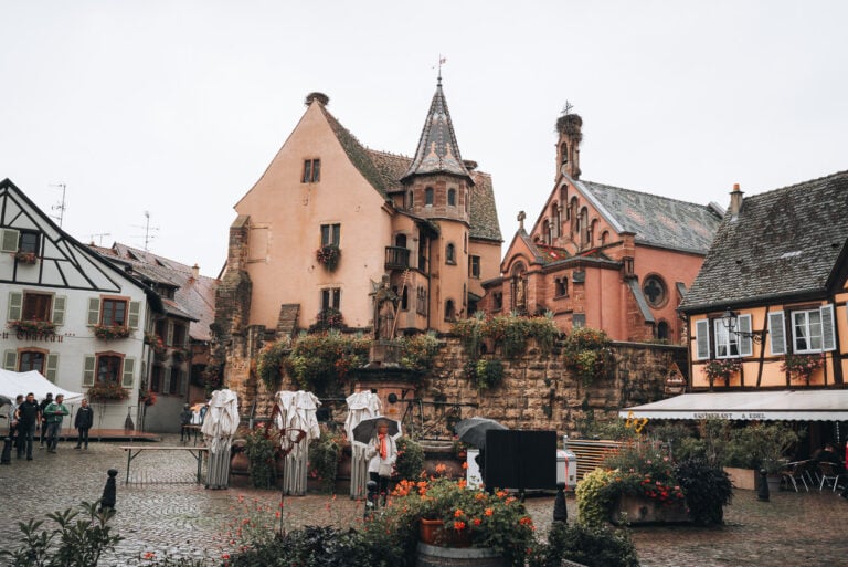 This is a photo of Saint-Leon Square in Eguisheim and there are locals who are setting up tents for the Fête des Vignerons (Winegrowers' Festival).