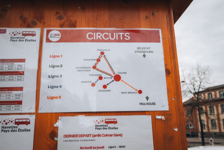 Sign for the Navettes de Noël in Colmar highlighting the five different circuits that are offered. It's posted at the main information office at the train station.