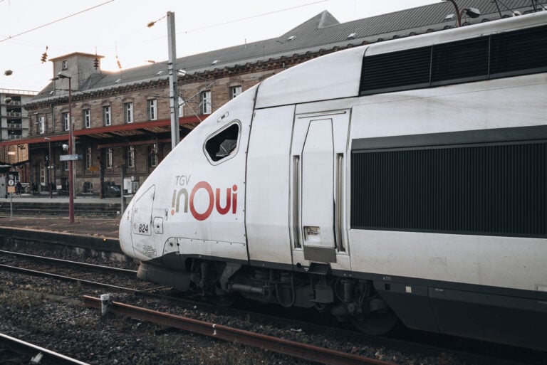 This is the front of a TGV train in France. There is the conductor's window and the TGV label on the front of the train.