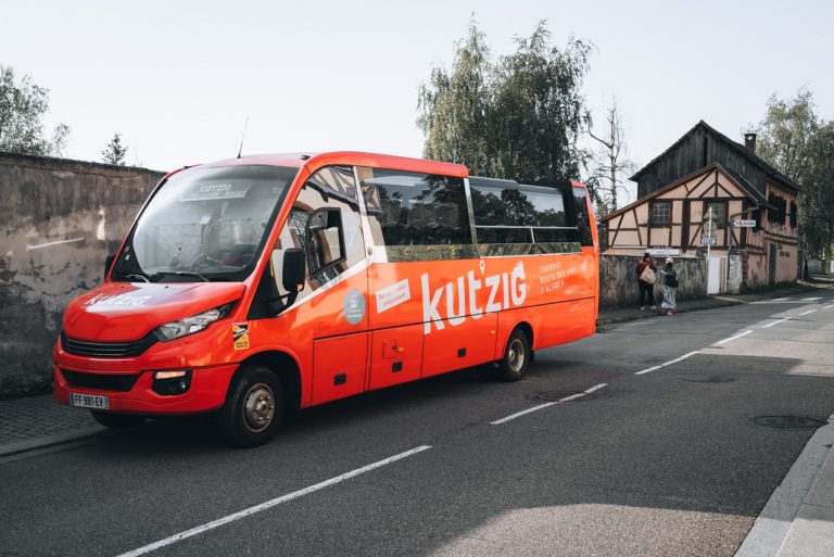 This is the Kutzig Bus parked in Riquewihr. It's a small bus with the name Kutzig written on the side.