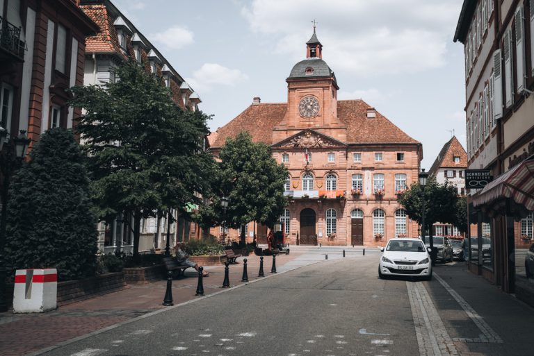 This is the town hall in Wissembourg. It's a tall red building with a clock tower.