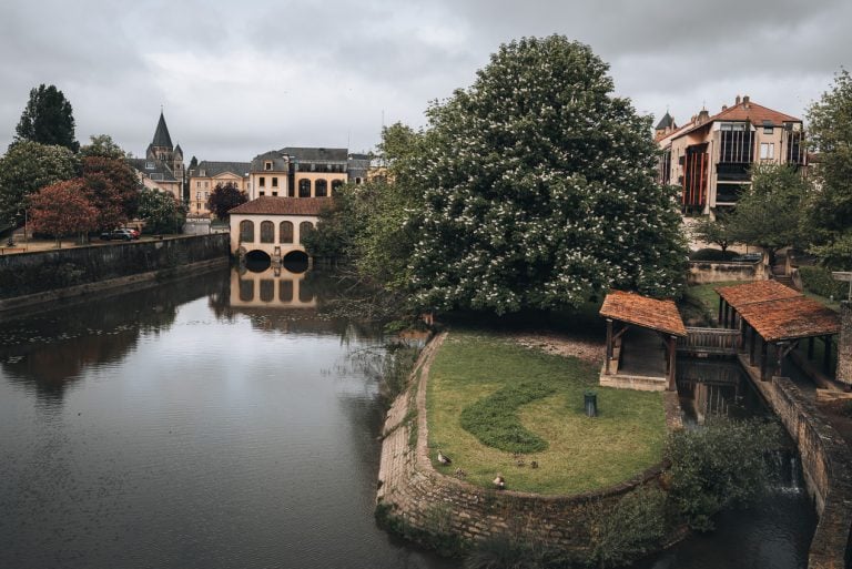 This is the view from View from Pont Saint-Georges in Metz just before in rains. There are buildings and the lavoir.