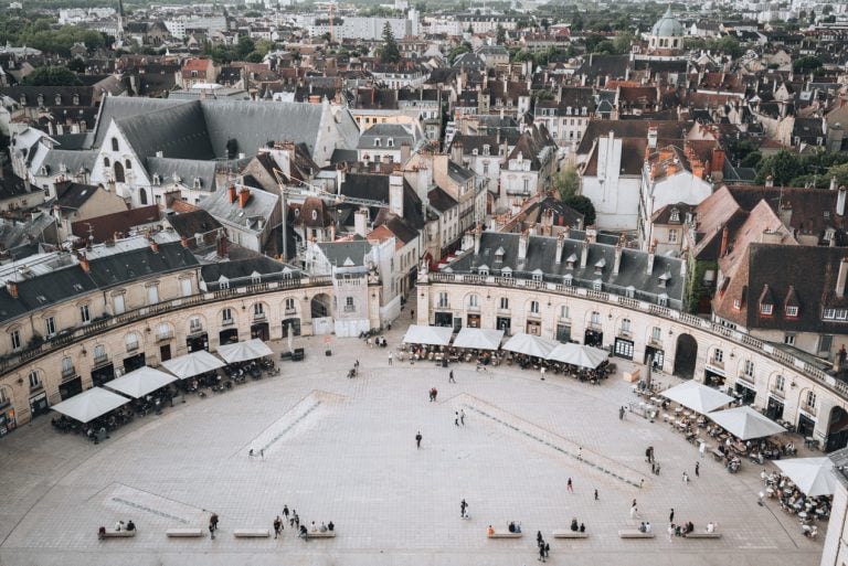 This is the view from Tour Philippe le Bon in Dijon. It shows Place de la Libération, which is a giant square surrounded by stone buildings.